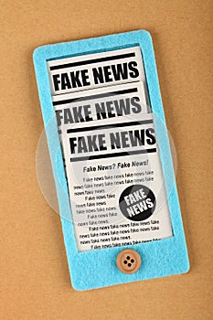 Felt craft smartphone with FAKE NEWS newspapers