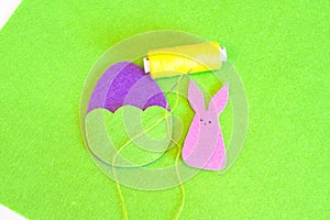 Felt Easter egg and bunny ornament. How to make handmade Easter ornament. Sewing craft concept. Kids sewing. Step