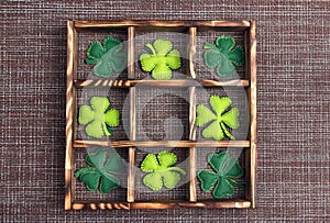 Felt four-leaf clover in the wooden box on sackcloth and cell copy space. Lucky shamrock, St.Patrick`s day holiday symbol