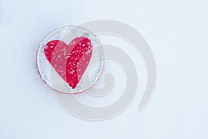 Felt hearts in a bowl on snow, Valentine`s Day