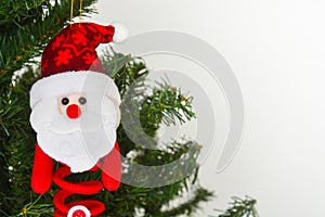 Felt santa claus doll hanging on Christmas tree, white background