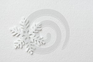 Felt snowflake on a white background. Winter, Christmas, New Year concept