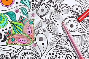 Felt tip pen on antistress coloring page, top view