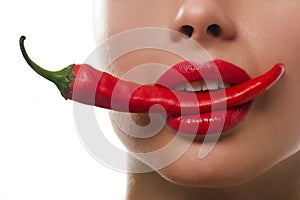 Femail mouth with red hot chilli pepper
