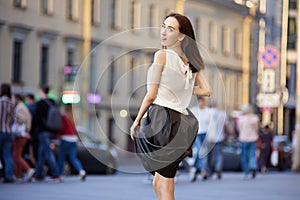 Female 18 years on crowded street in evening.