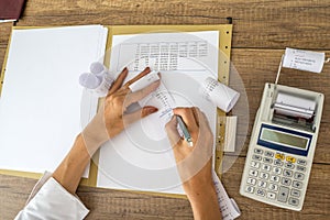 Female accountant or tax adviser working with receipts and statistical data photo