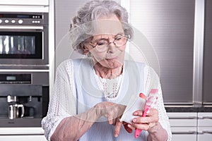 Female active pensioner is preparing strawberries