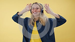 Female actively moving while listening music in dark wireless headset indoors