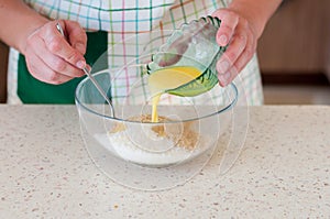 Female Adding Butter To Crushed Biscuits