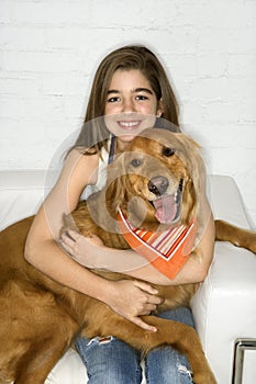 Female adolescent holding dog. photo