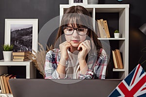 Female adolescent looking laptop screen