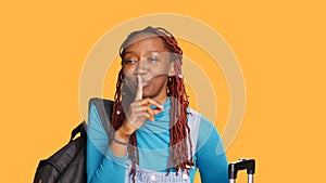 Female adult doing secrecy hush symbol