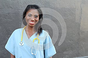 Female African American doctor or nurse smiling isolated over dark background