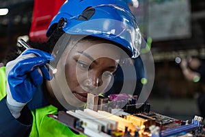 Female african american professional technician checking computer motherboard. engineering service repairing motherboard micro