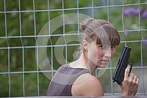 Female agent with gun hiding