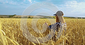 Female agronomist farmer with portable tablet computer