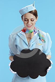 female air hostess on blue showing blank cloud shape board