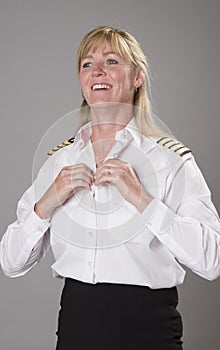 Female airline officer getting dressed