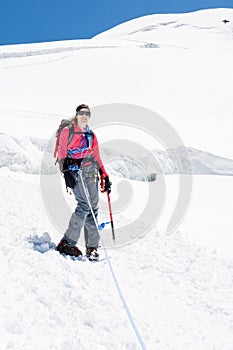 Female alpinist standing on glacier.