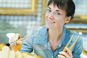 female antique restorator posing and smiling