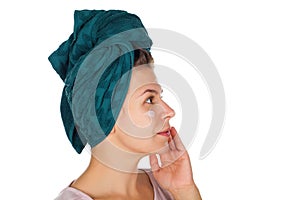 Female applying face moisturizer