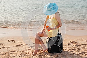 Female applying sun cream on Leg. Skincare Sun protection. Woman smear moisturizing lotionon on her smooth tanned legs