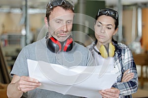 female apprentice carpenter with professor