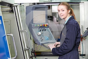 Female Apprentice Engineer Operating Computerized Cutting Machin