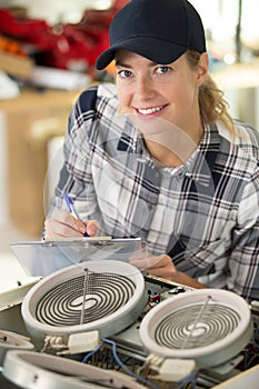 female apprentice engineer working on machine