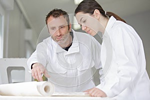 female apprentice training to use wallpaper