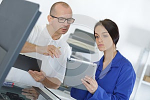 female apprentice using digital tablet