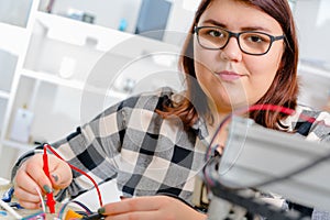 Female Apprentice working on CNC machinery.
