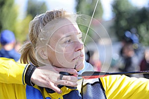 Female archer aiming at a mark on an archery shooting range