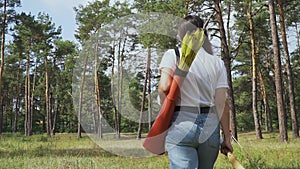 Female archer going through the forest.