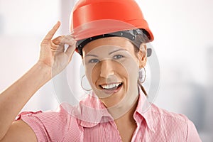 Female architect adjusting her hardhat