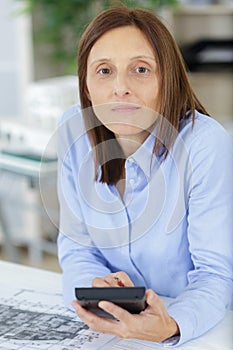 female architect with calculator