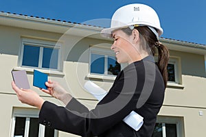 Female architect checking colours at large construction site photo