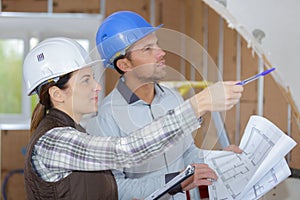 Female architect and coleague visiting large construction site