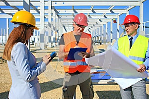 Female architect, construction engineer and manager on construction site