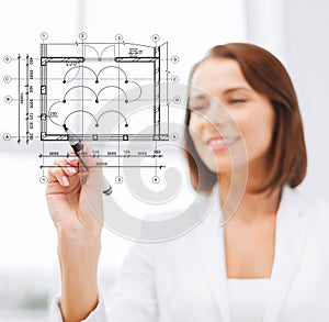 Female architect drawing blueprint