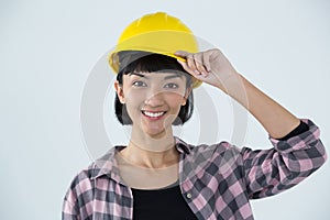 Female architect in hard hat standing against white background