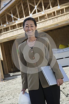 Female Architect With Hardhat And Laptop