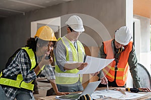 female architect holding walkie talkie and male civil engineer with working together inspection housing estate project