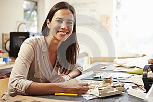 Female Architect Making Model In Office