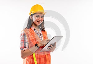 a female architect in savety waistcoat using the digital tablet