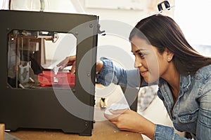 Female Architect Using 3D Printer In Office