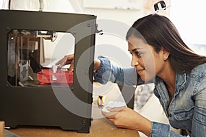 Female Architect Using 3D Printer In Office photo