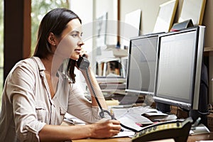 Female Architect Working At Desk On Computer