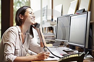 Female Architect Working At Desk On Computer