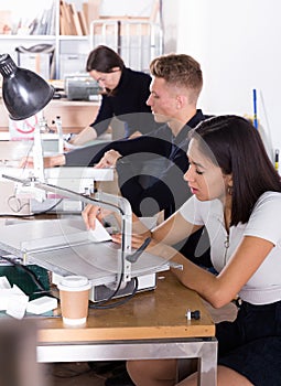 Female architect working on fret saw